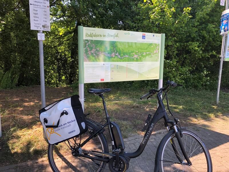 Fahrrad vor einem Schild mit Radwegen.